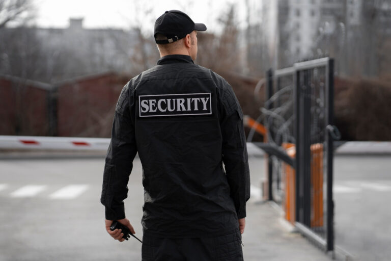 portrait-male-security-guard-with-barbed-wire-fence